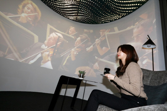 삼성물산 모델이 RAI 라이프관 홈오피스 공간에서 오페라를 감상하고 있다. RAI 라이프관의 홈오피스 공간은 사무, 홈스쿨링, 음악감상 등 다양한 용도로 활용 가능하다<삼성물산 건설부문 제공>